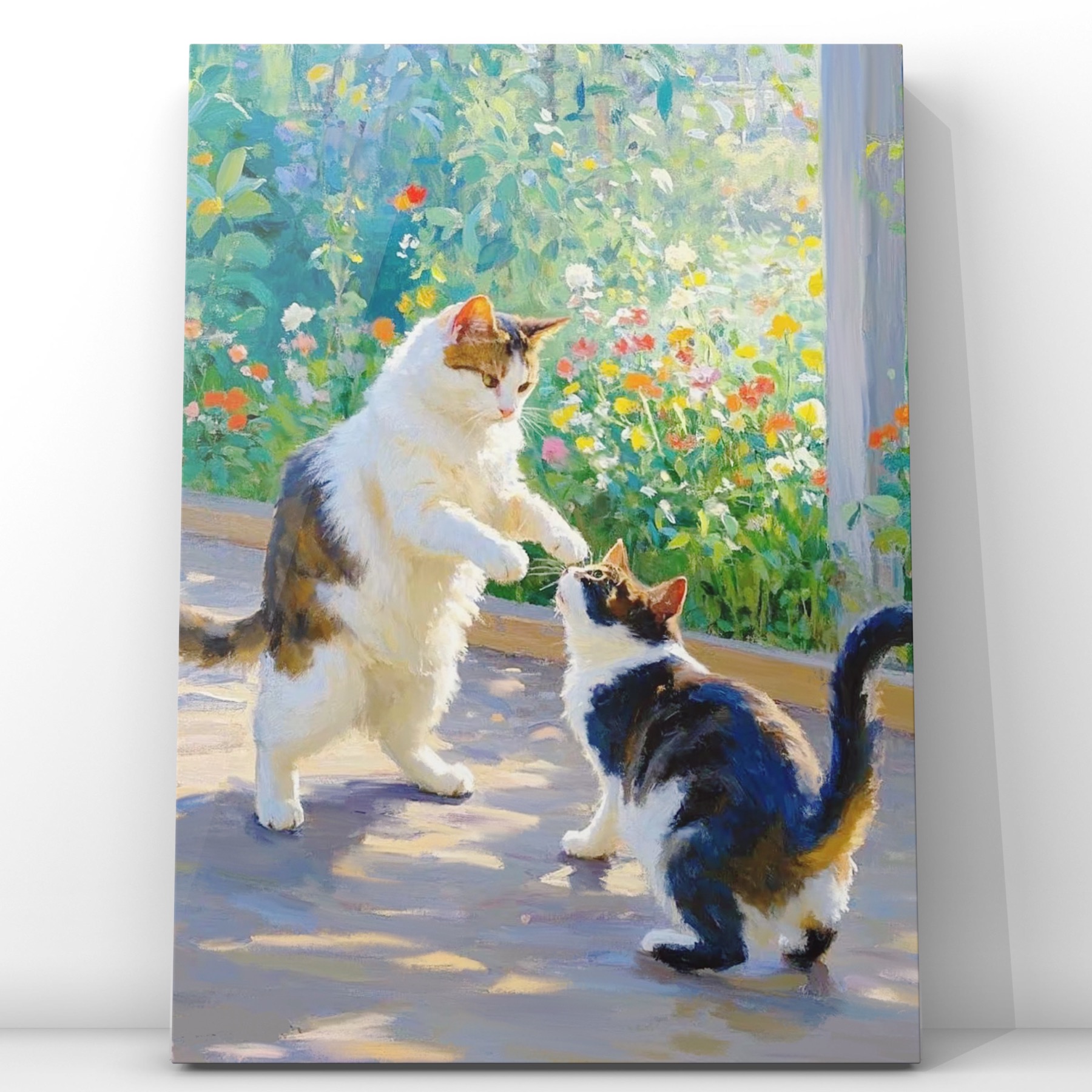 Two cats playing beside a sunlit garden filled with flowers